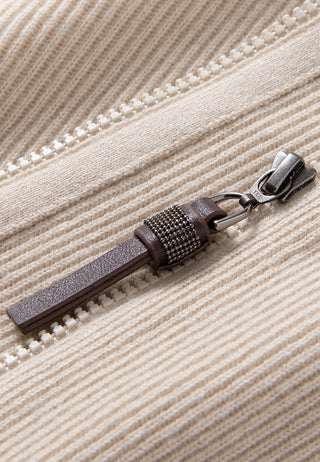 Close-up of camel ribbed cardigan zipper pull and metal slider on center front.