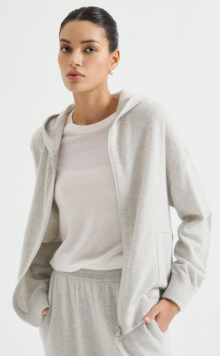 Light grey cashmere zip-up hoodie draped over shoulders, full front zipper, side pockets