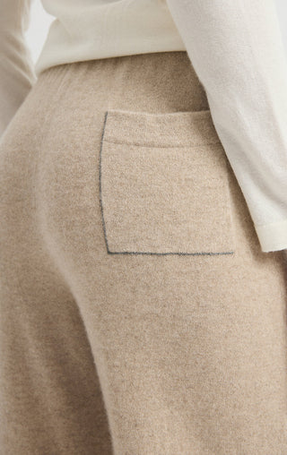 Camel cashmere pants with visible front pocket and smooth, soft knit finish
