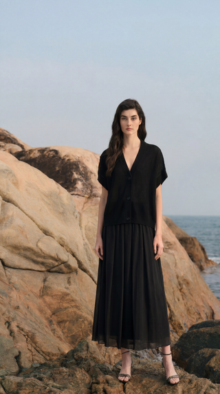 Black women’s summer knit outfit styled on a rocky coastal landscape with soft natural light