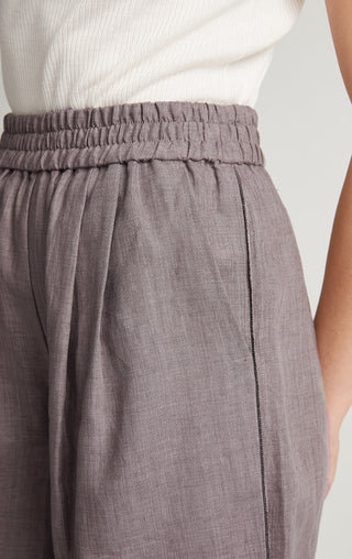 Gray linen elastic waistband and pleated front; vertical contrast trim on shorts.