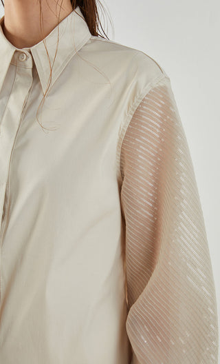 Apricot shirt close-up: cotton front with sheer sleeve overlay and button placket