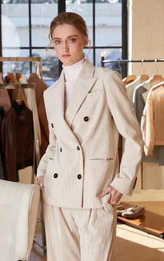 Cream shimmer pinstripe double-breasted blazer with peaked lapels and dark button front