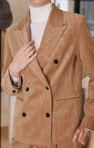 Close-up of brown shimmer pinstripe double-breasted blazer with black buttons and lapel