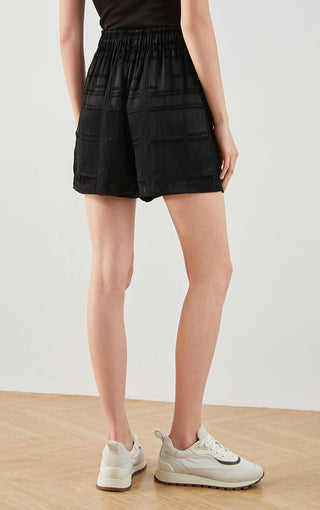 Black silk textured drawstring shorts, back view, elastic waist and patch pockets
