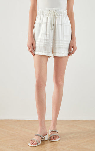 White silk textured drawstring shorts with elastic waist and patch pockets