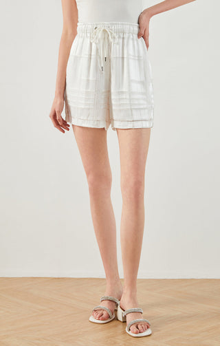 White silk drawstring shorts, side view, textured grid panels and drawcord