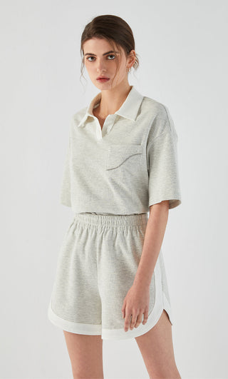 Light gray cotton stretch shorts with elastic waist, pocket detail, and white trim