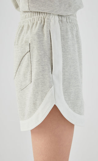 Light gray shorts close-up of back pocket and side slit with white trim