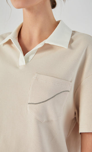 Apricot polo tee close-up of chest pocket and contrast-stitched polo collar