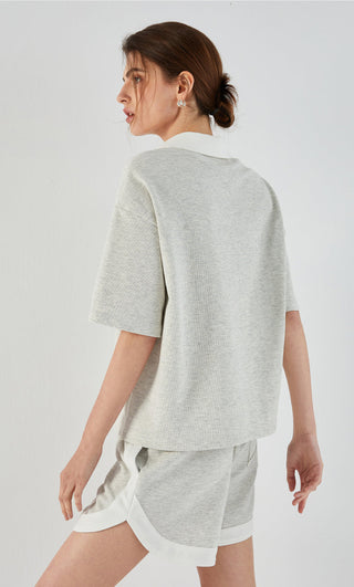 Light gray polo tee back view with short sleeves and collared neckline