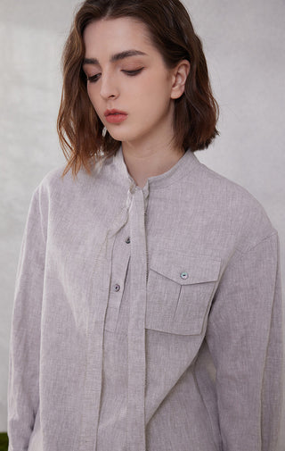 Light purple linen utility shirt close-up: tie-neck placket, buttons, and chest pocket