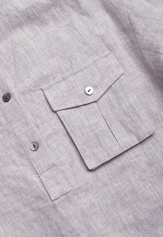 Light purple linen shirt cuff and pocket detail with white buttons