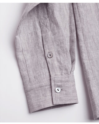 Light purple linen shirt cuff with button closure and folded sleeve seam