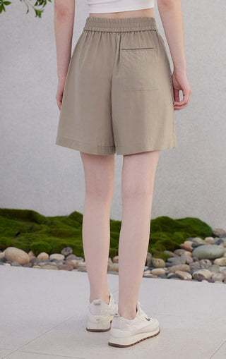 Light greige elastic waist shorts with two front pockets and roomy hem.