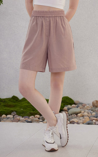 Rose-pink elastic-waist shorts with side seam detail and knee-length shorts hem.
