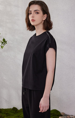 Black cotton short-sleeve top, crew neck, relaxed drape; side piping along sleeves