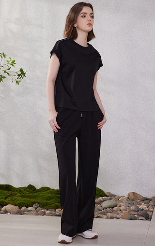 Black cotton short-sleeve top, crew neck, draped relaxed body with side piping