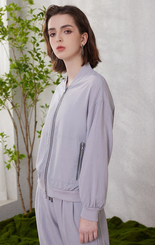 Light purple zip-front sunscreen hoodie with vertical pocket zipper detail and relaxed fit