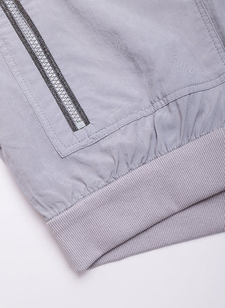 Hoodie hem close-up: ribbed cuff band under a zip-panel with cinched drawstring waist