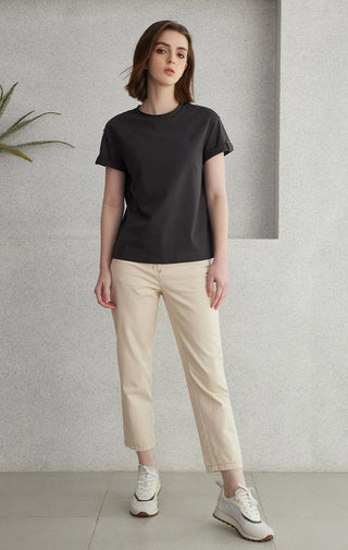 Black crew-neck minimal T-shirt with short sleeves, shown full-length on model