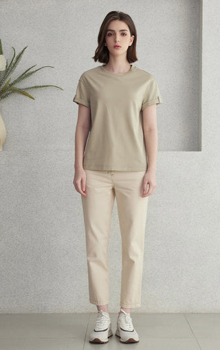 Khaki short-sleeve minimal T-shirt with crew neckline, styled with light pants
