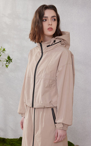 Camel hooded windbreaker jacket with black front zipper and contrast trim details