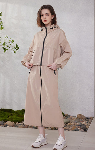 Camel hooded windbreaker jacket with black zipper, belted waist, and midi length
