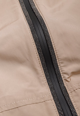 Camel fabric seam with black zipper tape and rhinestone-style trim stripe