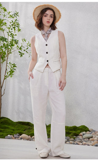 White linen sleeveless vest with dark buttons and fitted waist panel