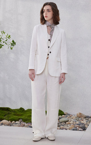 White linen relaxed straight-leg pants, side-view with tapered wide leg and hem buttons
