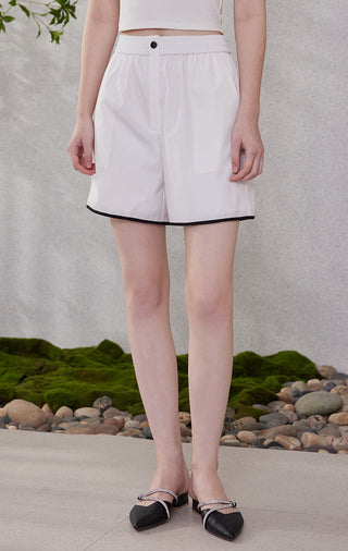 White stretch lightweight elastic-waist shorts, front view with black-trim hem