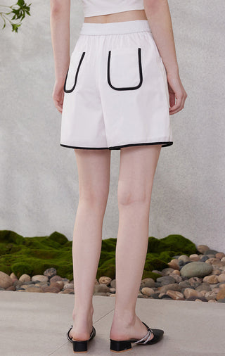 White shorts with U-shaped back pocket and black-edged hem, elastic waistband