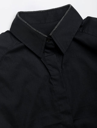 Black sleeveless structured shirt with pointed collar, button placket, and contrast trim.