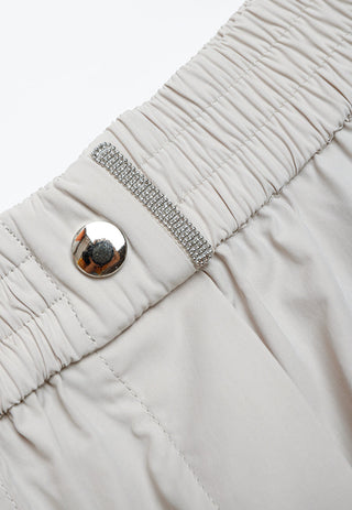 Light gray elastic-waist shorts with rhinestone-beaded trim and round snap button