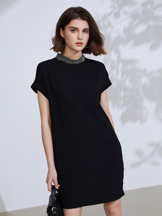 Black short-sleeve shift dress with embroidered necklace-style trim at crew neckline