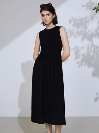 Black sleeveless midi dress with high neckline and gathered, pleated skirt