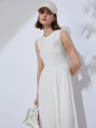 White sleeveless midi dress with gathered waist and flowing pleated skirt