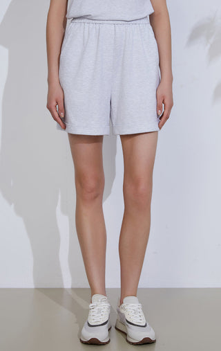 Light gray relaxed knit shorts with elastic waistband, side pockets, above-knee length