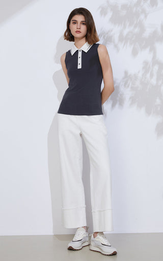 Black cotton-blend sleeveless polo front with white collar trim and button placket