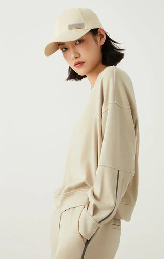 Sage green sweatshirt, side view with relaxed sleeves and cuff detailing