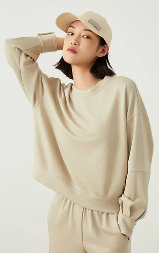 Sage green crewneck sweatshirt with draped fit and visible cuff seams