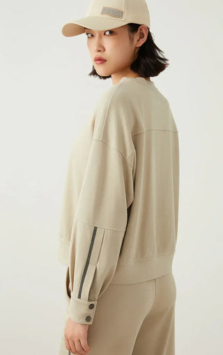 Sage green sweatshirt side view, loose fit and detailed sleeve cuff