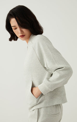 Light gray zip-up jacket side view with front zipper and slanted hand pockets.