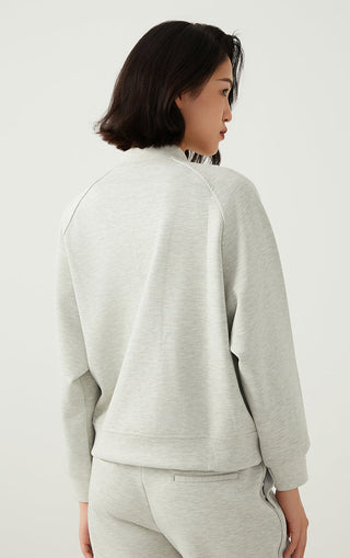 Light gray zip-up jacket back view with long sleeves and seam stitching details.