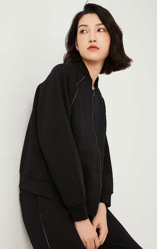 Black zip-up jacket, front zipper closure and relaxed shoulder seams.