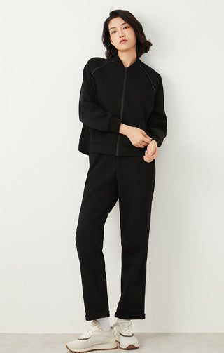 Black zip-up jacket with front zipper and matching straight-leg pants set style.