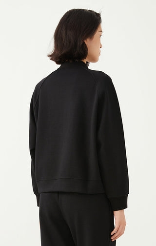 Black zip-up jacket back view with long sleeves and visible seam stitching.
