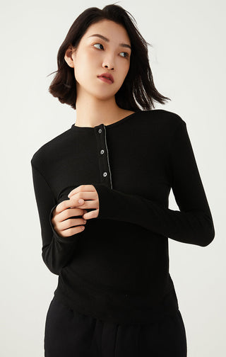 Black long-sleeve henley top with buttoned placket and rounded neckline