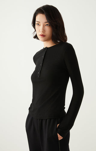 Black long-sleeve henley top with three-button placket and rounded neckline
